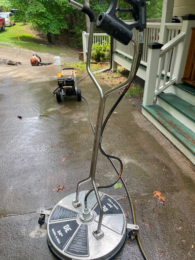 Pressure washing a residential concrete surface